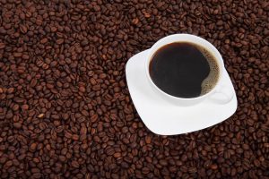 10638-a-cup-of-coffee-on-a-bean-background-pv